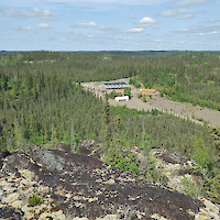 View to the northeast of our 20 man camp, with the 75,000 litre fuel tank in the foreground, and the orange sewage treatment plant to the right on the Mon Gold Mine site.  Photo taken by mine manager Rodney McKay, from on top of the A-Zone gold deposit.  The gravel field in the foreground is the historic, capped and covered tailings storage facility from operations in the 1990's.